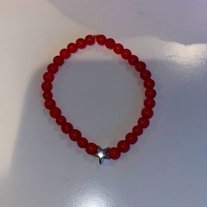 Red beaded bracelet with silver star